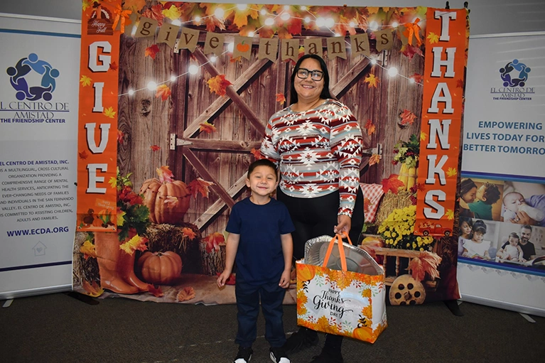 Mother and toddler at the El Centro de Amistad Thanksgiving event